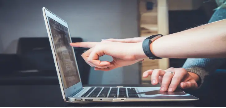 Person pointing at an Automation page on a laptop