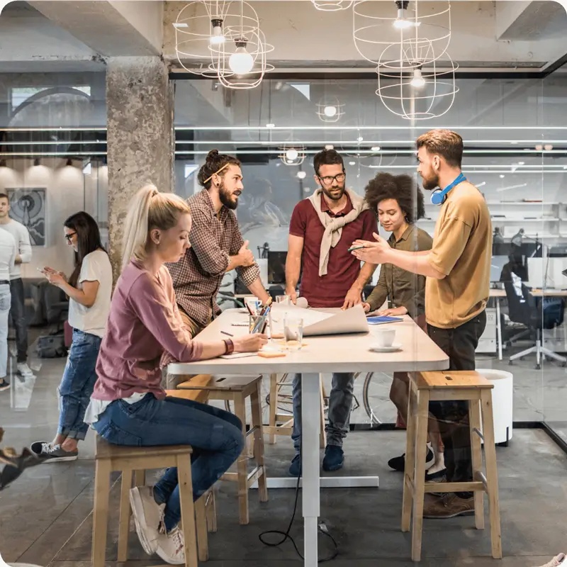 Several people having a meeting in a modern workplace